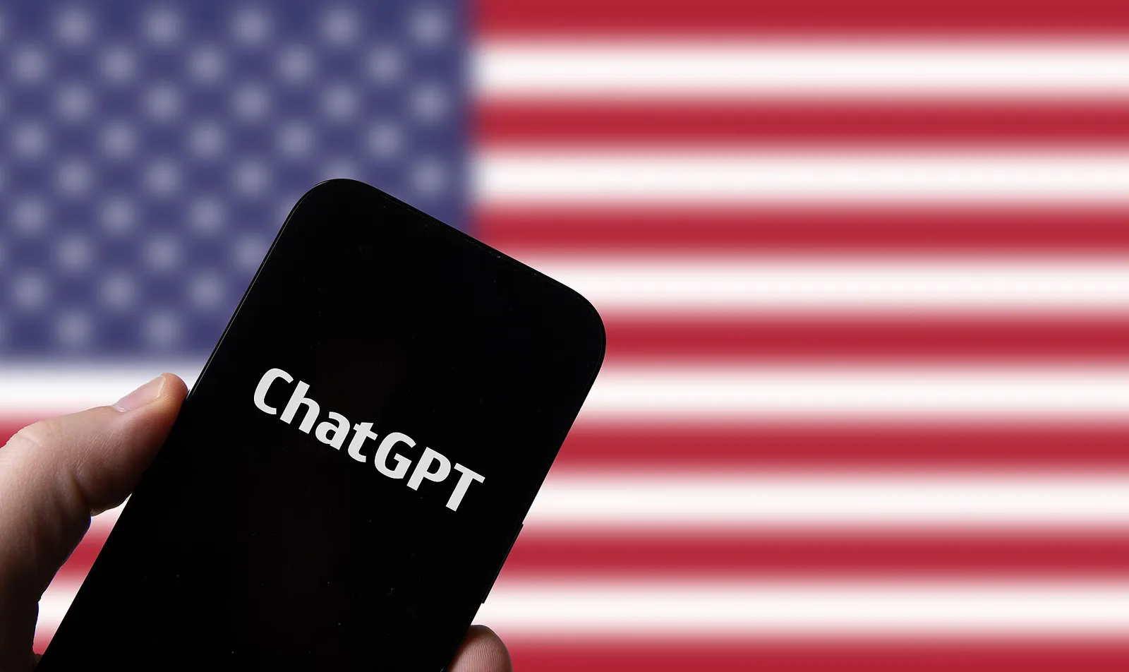 Een smartphone met de ChatGPT-app tegen een Amerikaanse vlag (ter illustratie)